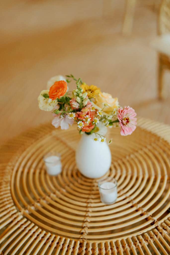 Bud vase of flowers provide a pop of colour to Wedding Reception.