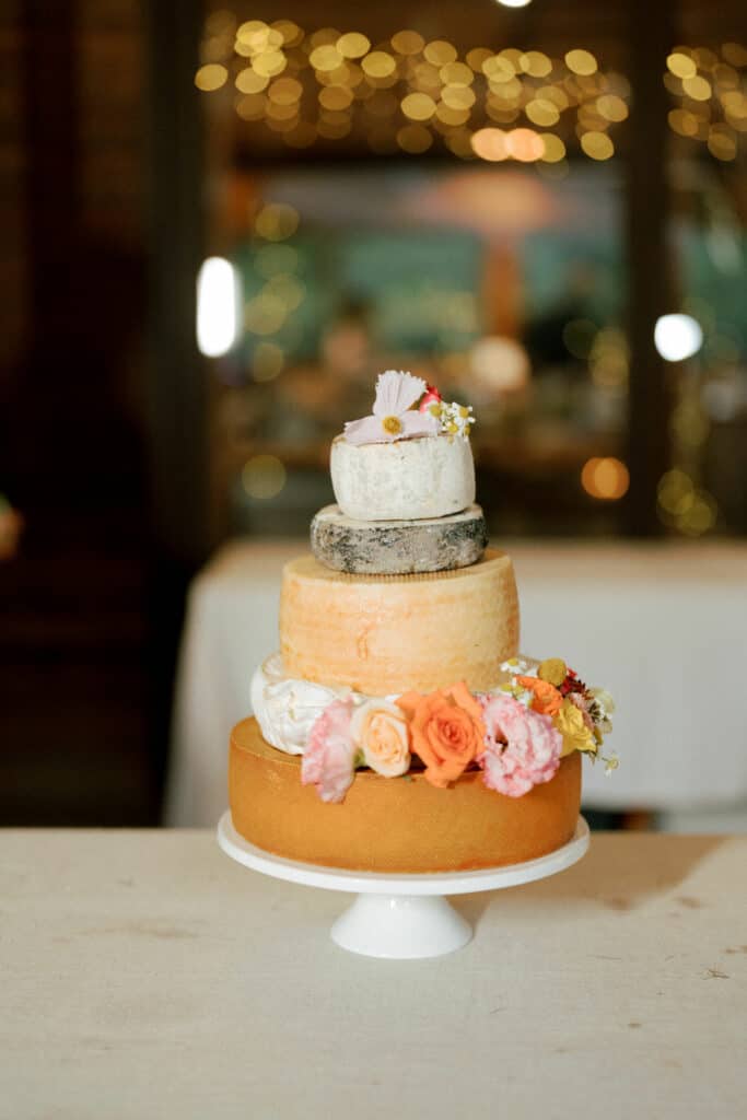 Wedding cake made from cheese wheels decorated by flowers