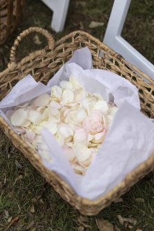 A basket lined with tissue and filled with rose petals for the guests to throw at the end of the wedding ceremony